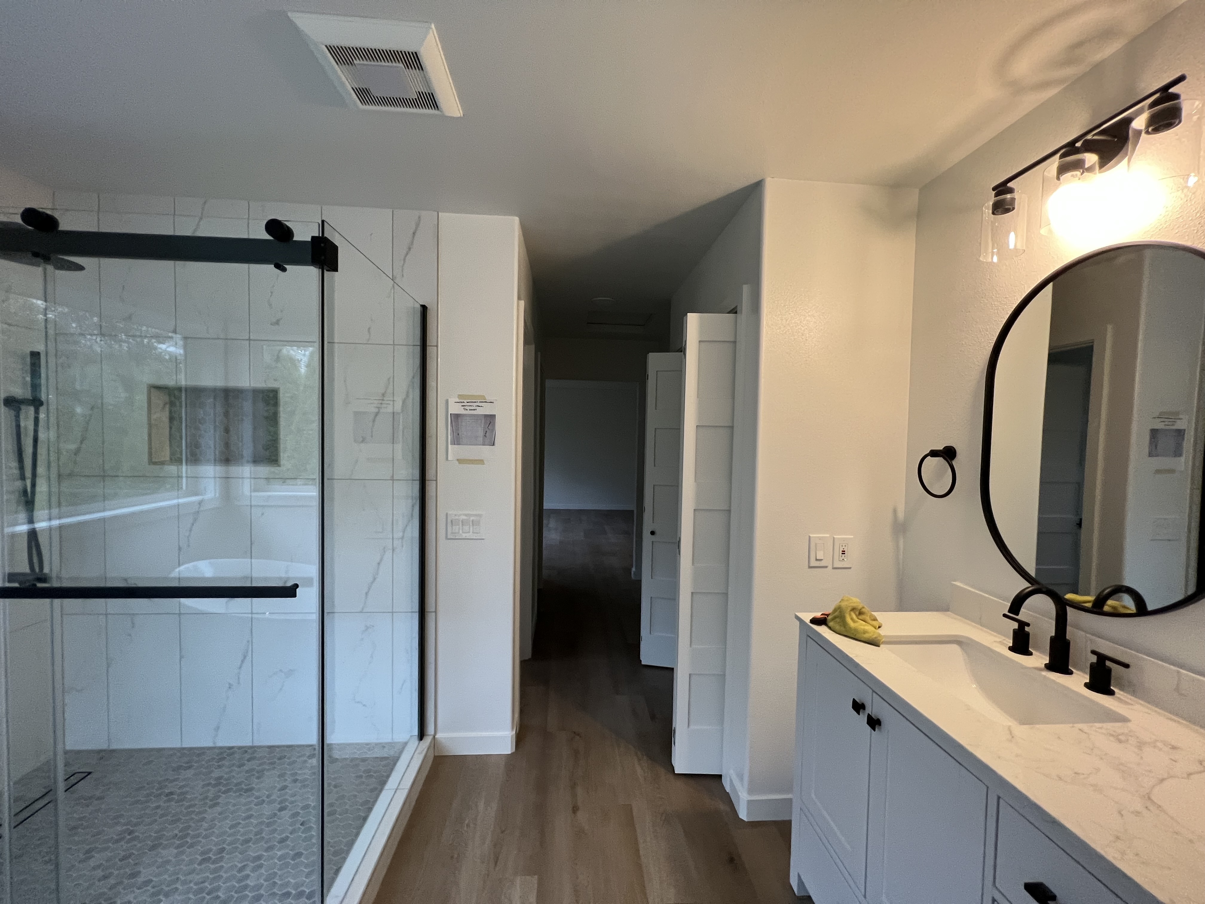 Bathroom remodel with tile shower, vanity, and custom storage